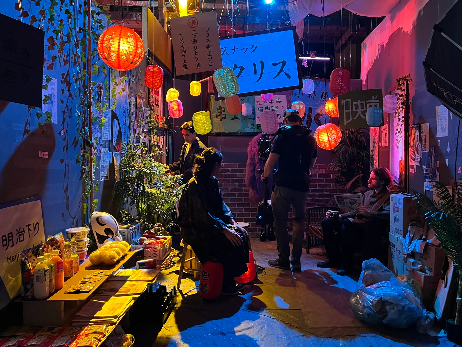 Practical lanterns, scenic signs and layered shopfronts on the Poppy Lissiman set